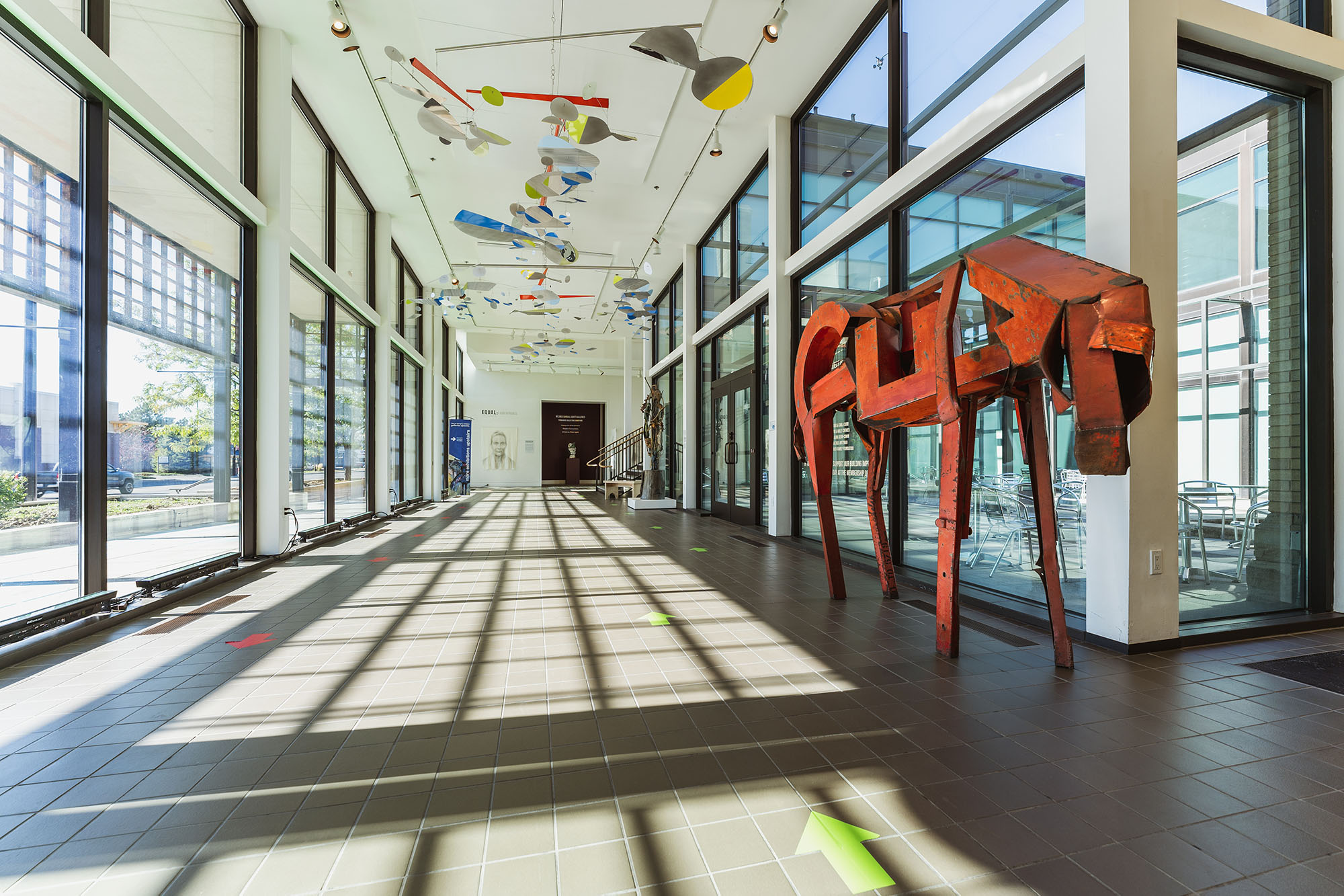 Photo of foyer of the yellowstne art museum with sculpture of a horse and mobile.